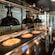 Three large pizzas under heat lamps at Pizza Planet on the Disney Adventure cruise ship